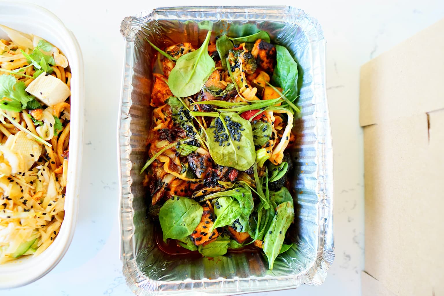 Shared restaurant meal with leftovers boxed