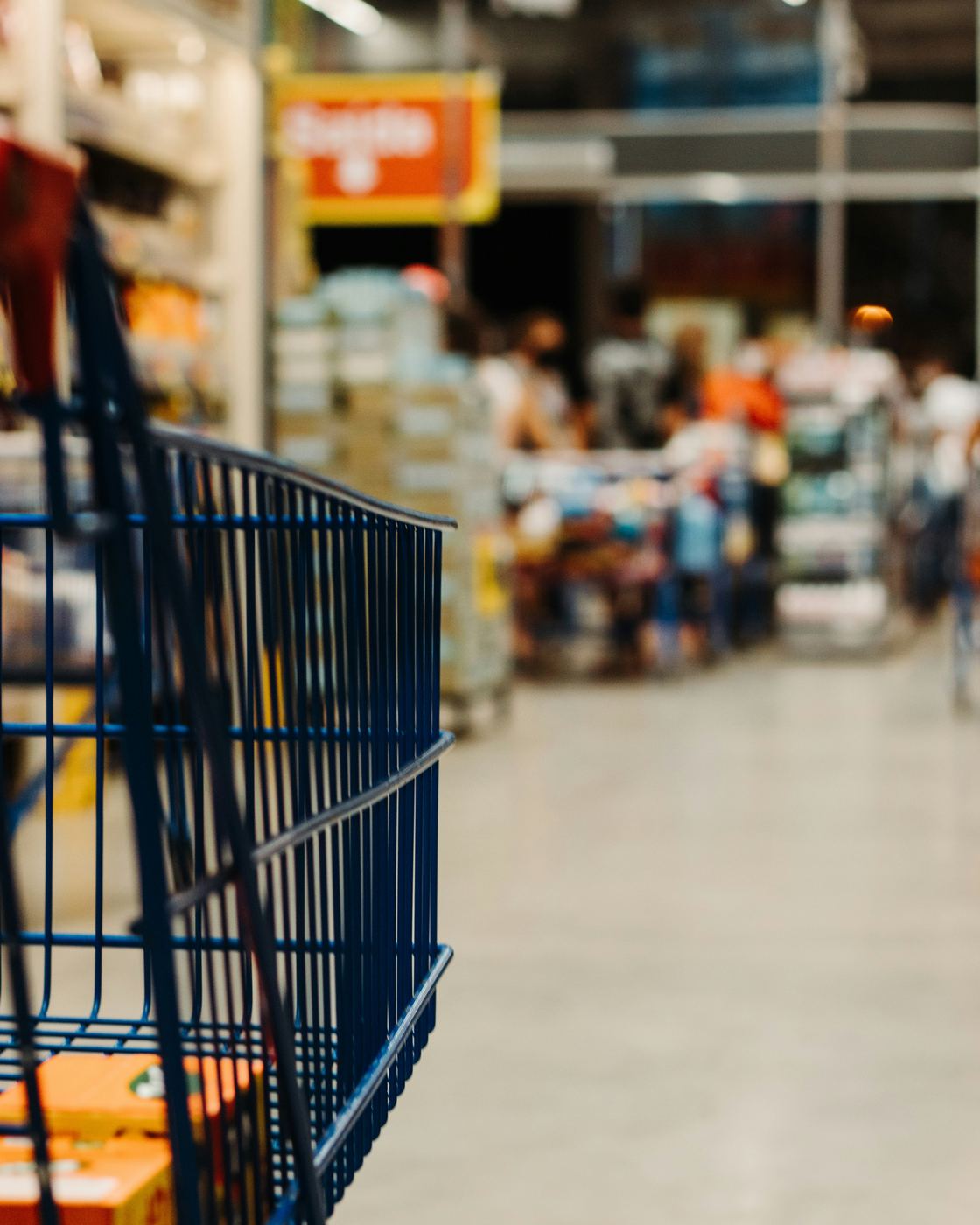 A shopping cart in a grocery store aisle